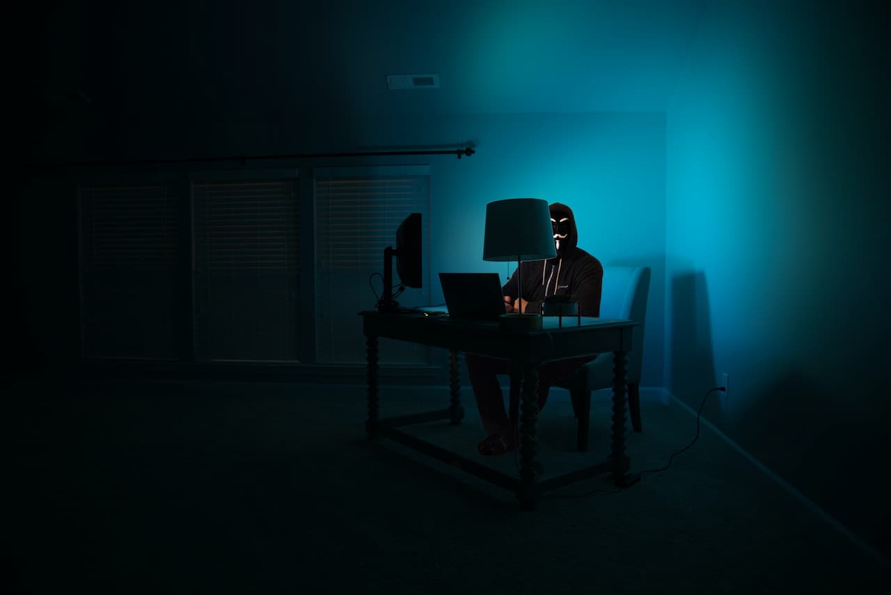 Robotic man coding at computer